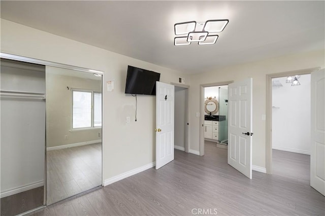 12246 Nadine Cir, Garden Grove, CA 92840 - unfurnished bedroom with baseboards, wood finished floors, and a closet