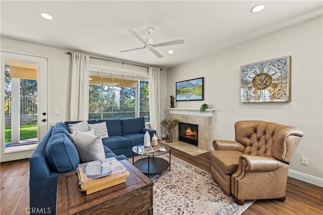 23664 Clearidge Dr, Valencia, CA 91354 - living area with wood finished floors, ceiling fan, recessed lighting, a high end fireplace, and baseboards