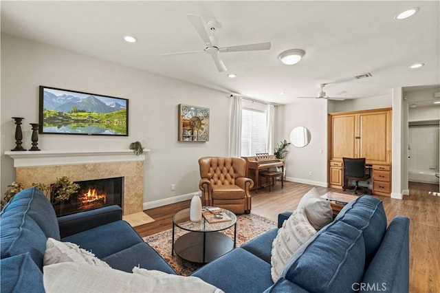 23664 Clearidge Dr, Valencia, CA 91354 - living area featuring ceiling fan, wood finished floors, recessed lighting, baseboards, and a high end fireplace