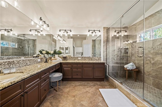 23664 Clearidge Dr, Valencia, CA 91354 - bathroom featuring double vanity, a shower stall, lofted ceiling, and tile patterned flooring