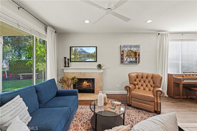23664 Clearidge Dr, Valencia, CA 91354 - living area featuring wood finished floors, recessed lighting, a high end fireplace, a ceiling fan, and baseboards