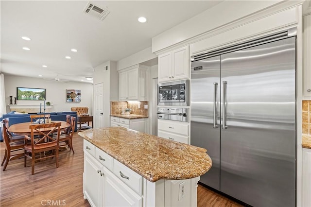 23664 Clearidge Dr, Valencia, CA 91354 - kitchen with built in appliances, backsplash, recessed lighting, light stone counters, and light wood finished floors