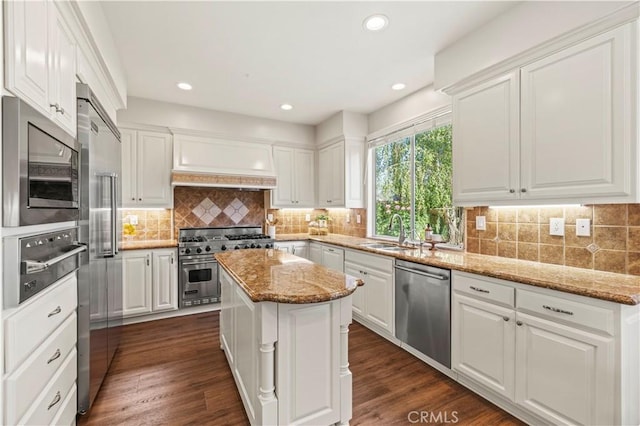 23664 Clearidge Dr, Valencia, CA 91354 - kitchen with built in appliances, a sink, white cabinets, a warming drawer, and premium range hood