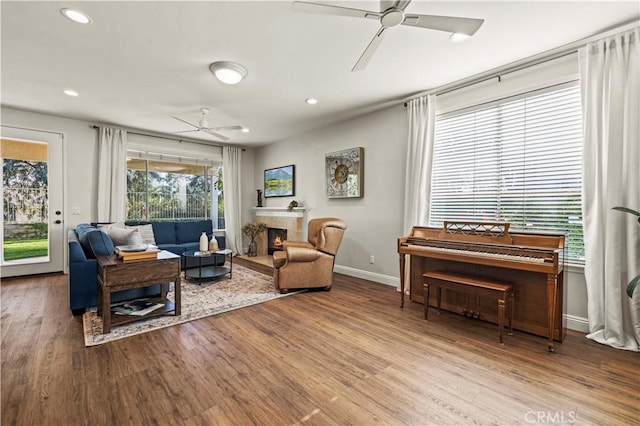 23664 Clearidge Dr, Valencia, CA 91354 - living room featuring ceiling fan, wood finished floors, recessed lighting, and a warm lit fireplace