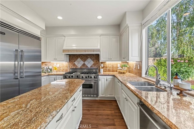 23664 Clearidge Dr, Valencia, CA 91354 - kitchen with high quality appliances, a sink, white cabinetry, light stone countertops, and dark wood-type flooring