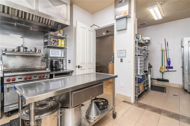 39312 Beringer Dr, Murrieta, CA 92563 - kitchen with high end stove, tile patterned floors, open shelves, and baseboards