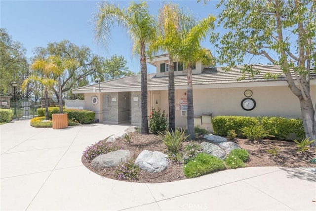 39312 Beringer Dr, Murrieta, CA 92563 - view of front facade featuring stucco siding, a gate, fence, and a tile roof