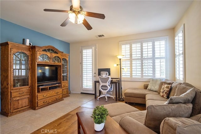 39312 Beringer Dr, Murrieta, CA 92563 - living area featuring plenty of natural light, a ceiling fan, light wood-type flooring, and baseboards