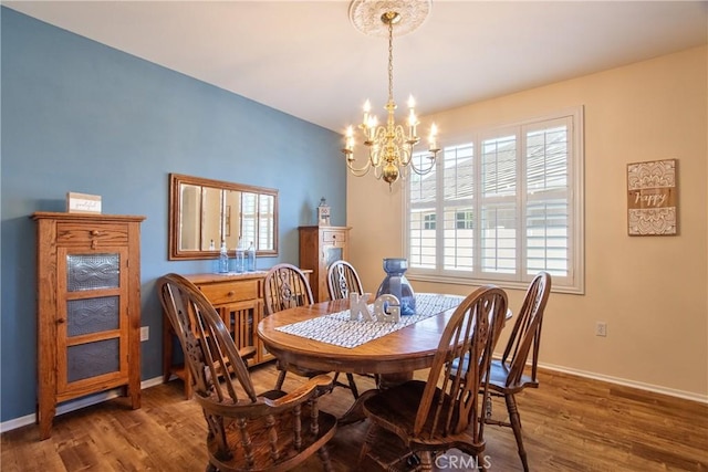 39312 Beringer Dr, Murrieta, CA 92563 - dining space with a chandelier, wood finished floors, and baseboards