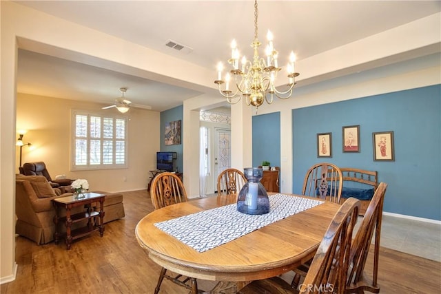 39312 Beringer Dr, Murrieta, CA 92563 - dining area featuring a chandelier, wood finished floors, baseboards, and ceiling fan