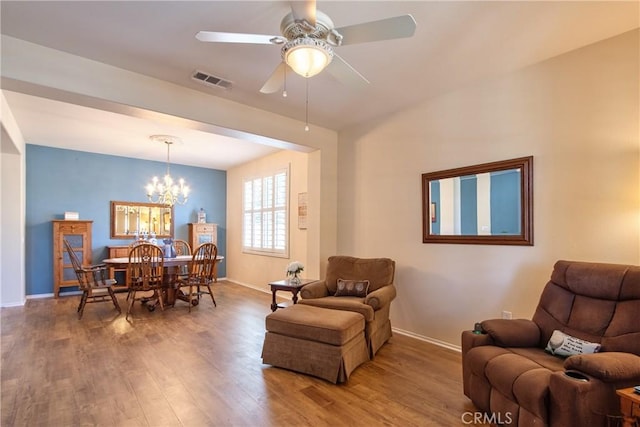 39312 Beringer Dr, Murrieta, CA 92563 - living room featuring wood finished floors, baseboards, a chandelier, and a ceiling fan