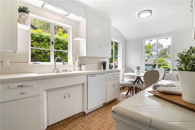 438 S Lamer St, Burbank, CA 91506 - kitchen featuring white dishwasher, tile counters, a sink, decorative backsplash, and white cabinetry