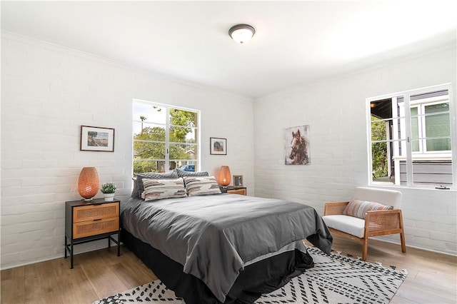 438 S Lamer St, Burbank, CA 91506 - bedroom with light wood-style floors, ornamental molding, and brick wall