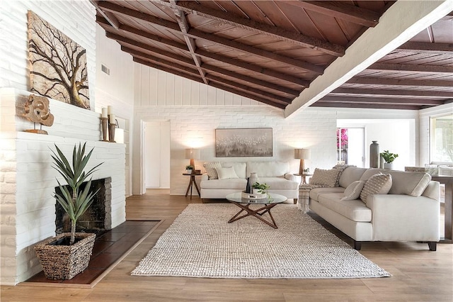 438 S Lamer St, Burbank, CA 91506 - living area with wooden ceiling with exposed beams, high vaulted ceiling, wood finished floors, and a fireplace