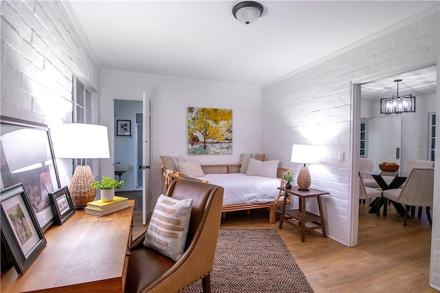 438 S Lamer St, Burbank, CA 91506 - bedroom with light wood-style flooring, a chandelier, ornamental molding, and brick wall
