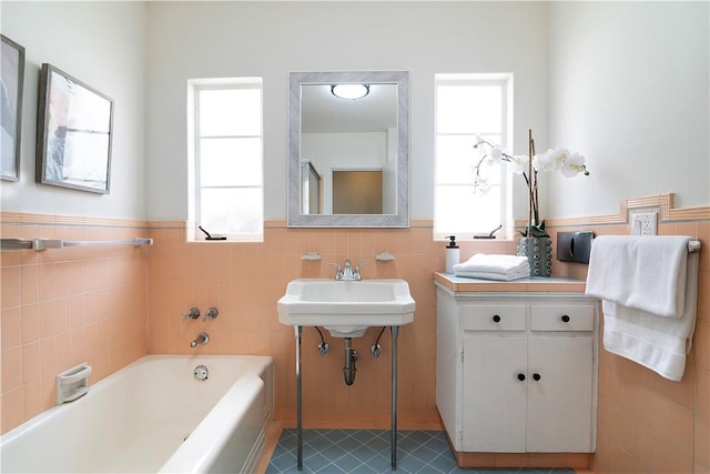 438 S Lamer St, Burbank, CA 91506 - bathroom with tile walls, a garden tub, a wainscoted wall, plenty of natural light, and a sink