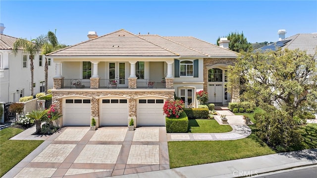 7 Rue Delacroix, Coto De Caza, CA 92679 - view of front of property featuring a chimney, stucco siding, decorative driveway, stone siding, and a balcony