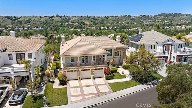 7 Rue Delacroix, Coto De Caza, CA 92679 - view of front of house featuring an attached garage, driveway, stone siding, and a residential view