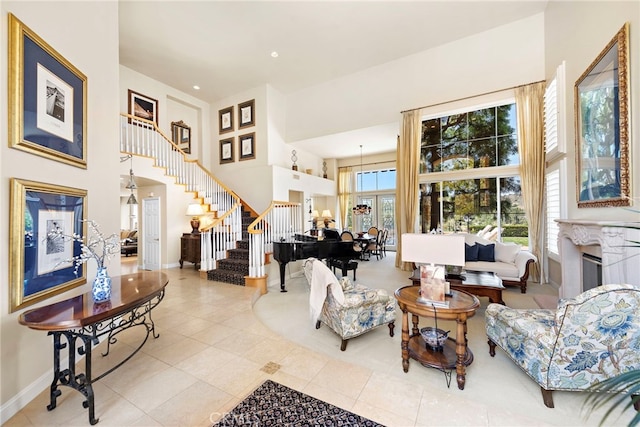 7 Rue Delacroix, Coto De Caza, CA 92679 - tiled living area with a towering ceiling, stairway, baseboards, a fireplace, and recessed lighting