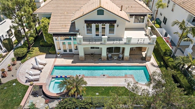 7 Rue Delacroix, Coto De Caza, CA 92679 - rear view of house featuring a balcony, french doors, stucco siding, and a tiled roof