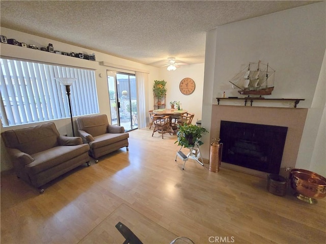 5805 Whitsett Ave Unit 102, Valley Village, CA 91607 - living room with ceiling fan, a fireplace, a textured ceiling, and wood finished floors