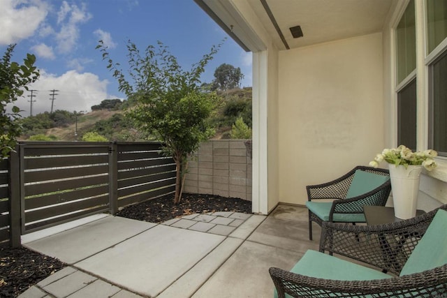 view of patio featuring fence