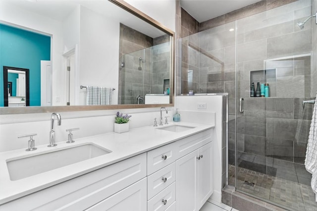 bathroom featuring double vanity, a sink, and a shower stall