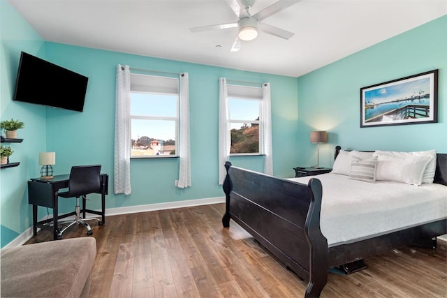 bedroom with baseboards, ceiling fan, and wood finished floors