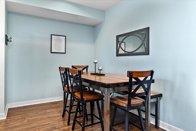 dining room with baseboards and dark wood finished floors