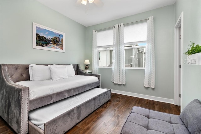 bedroom featuring baseboards, ceiling fan, and wood finished floors