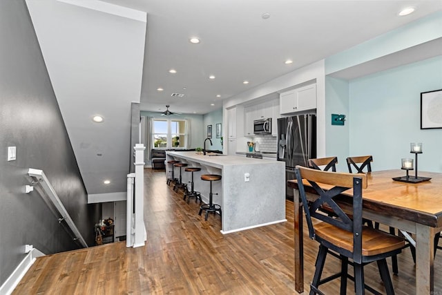 dining area featuring recessed lighting, ceiling fan, wood finished floors, and visible vents