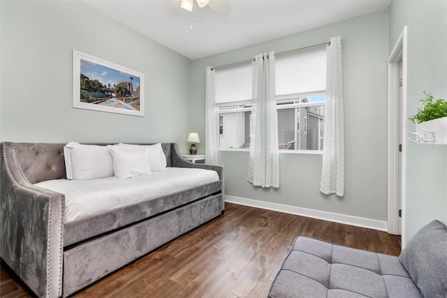 bedroom featuring a ceiling fan, baseboards, and wood finished floors