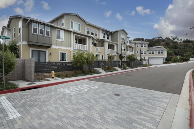 view of road with a residential view, sidewalks, and curbs
