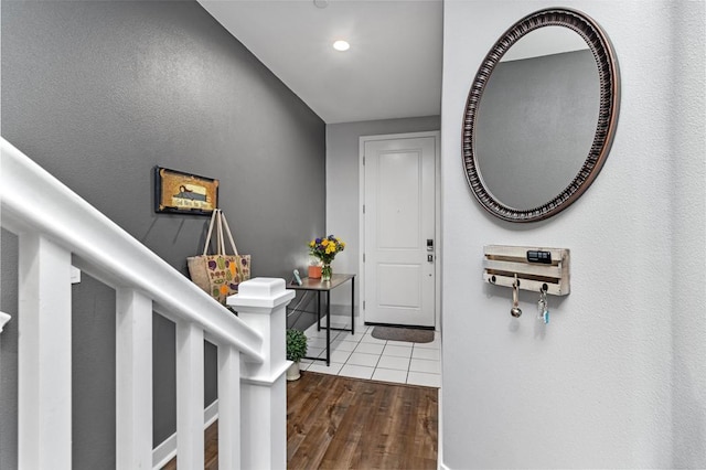 entryway featuring baseboards, recessed lighting, and wood finished floors