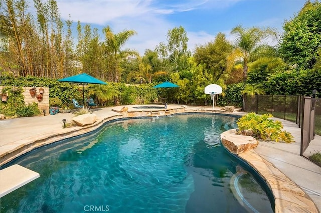 view of pool with a patio area, an in ground hot tub, fence, and a fenced in pool