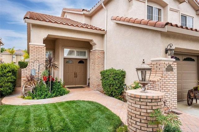 entrance to property with stucco siding, a tile roof, and brick siding