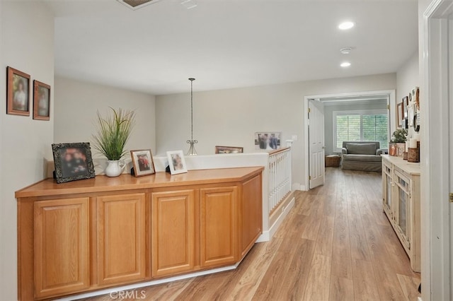 28433 Pinewood Ct, Saugus, CA 91390 - kitchen featuring light wood finished floors, recessed lighting, light countertops, a peninsula, and decorative light fixtures