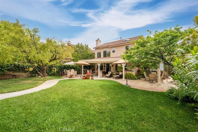 28433 Pinewood Ct, Saugus, CA 91390 - back of property featuring a chimney, a lawn, a patio area, stucco siding, and a tile roof