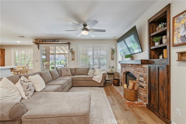 28433 Pinewood Ct, Saugus, CA 91390 - living room with light wood-style flooring, healthy amount of natural light, ceiling fan, a fireplace, and recessed lighting