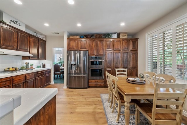 28433 Pinewood Ct, Saugus, CA 91390 - kitchen with stainless steel appliances, under cabinet range hood, light wood finished floors, plenty of natural light, and recessed lighting