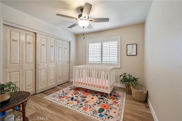 28433 Pinewood Ct, Saugus, CA 91390 - bedroom featuring light wood-style floors, a closet, a ceiling fan, and a crib