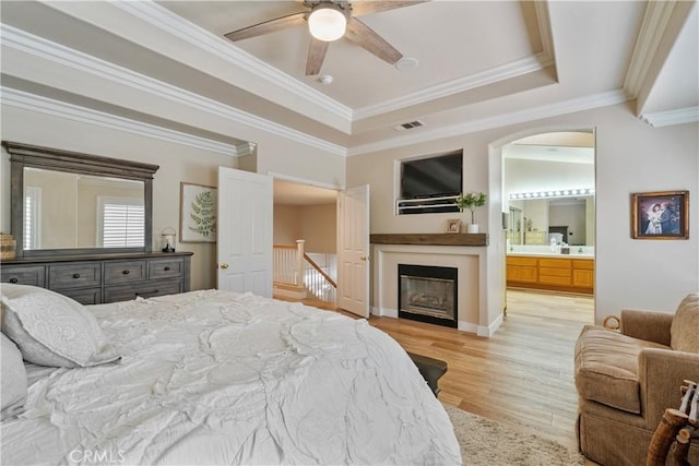 28433 Pinewood Ct, Saugus, CA 91390 - bedroom featuring light wood-type flooring, a raised ceiling, arched walkways, crown molding, and ensuite bathroom