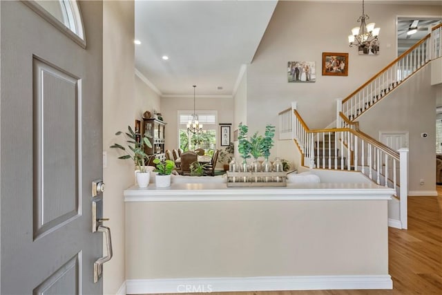 28433 Pinewood Ct, Saugus, CA 91390 - foyer featuring a chandelier, stairway, wood finished floors, ornamental molding, and recessed lighting