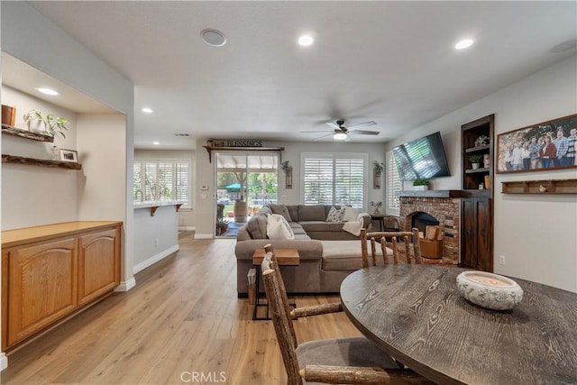 28433 Pinewood Ct, Saugus, CA 91390 - dining space featuring a ceiling fan, light wood-style floors, recessed lighting, and a fireplace