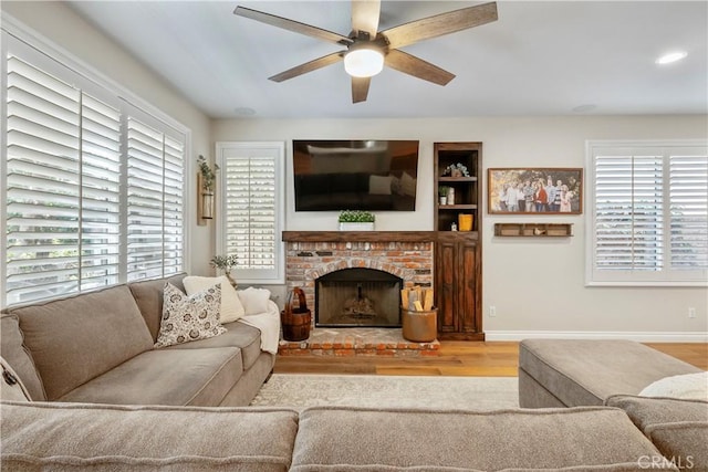 28433 Pinewood Ct, Saugus, CA 91390 - living room featuring ceiling fan, wood finished floors, and a fireplace