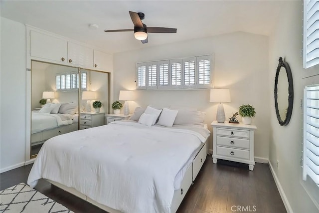bedroom featuring baseboards, ceiling fan, a closet, and dark wood-style floors