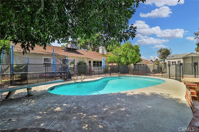 view of pool featuring a patio, a fenced in pool, and fence