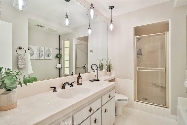 full bath with toilet, visible vents, a shower stall, and vanity