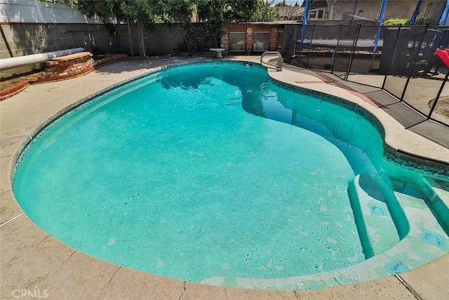 view of pool with a patio, a fenced in pool, and a fenced backyard