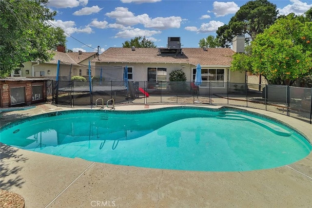 view of pool featuring fence, a fenced in pool, and a patio area